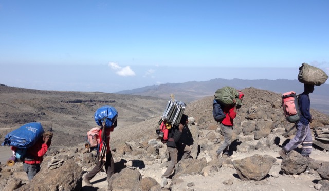 Kilimanjaro porters carrying bags - photo by Lynn Jackson